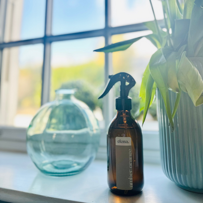 elena london amber orange room spray styled in a bright home interior